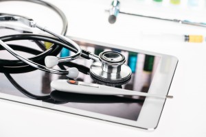 Medical Calibration Services - close up view of stethoscope and thermometer on digital tablet on white