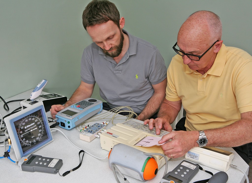 Medical Equipment Calibration - Two engineers looking at a readout